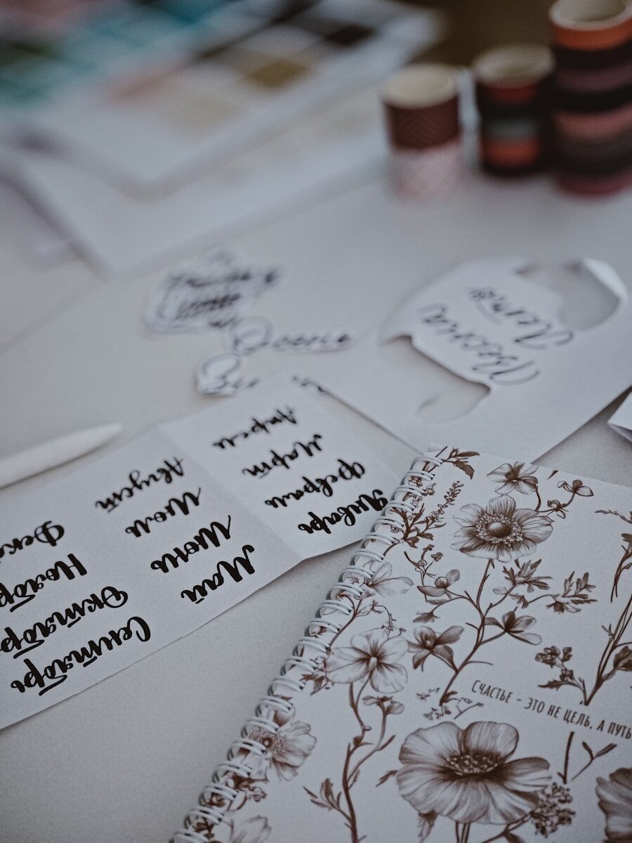 Stationery and supplies are arranged on a white table.
